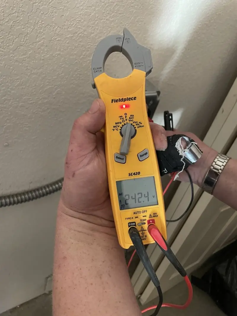 Voltage testing with clamp meter during Recessed Lighting Installation in Tarboro